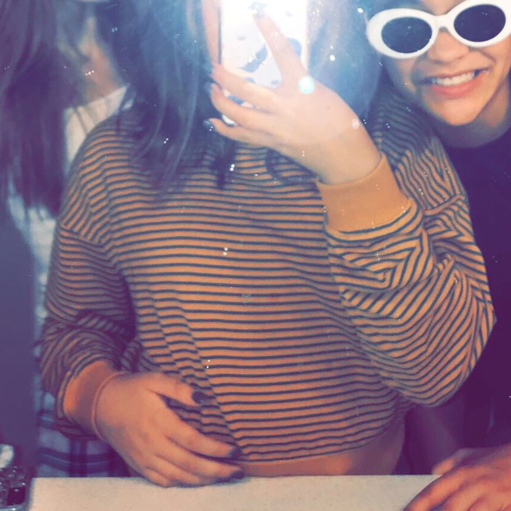 Selling a striped long sleeve w ripped jeans :)